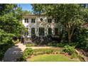 Beautiful two-story home with lush greenery and a well-manicured front yard at 21 Barksdale Ne Dr, Atlanta, GA 30309