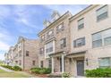 Attractive brick townhomes featuring covered entries, neutral brick, and landscaped frontage at 2252 Talmai Dr, Snellville, GA 30078