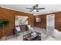 Cozy living room featuring wood paneled walls, stylish seating, and contemporary decor at 389 Oglesby Bridge Se Rd, Conyers, GA 30094