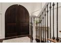 Grand foyer with dark wood double doors, a staircase, and detailed trim showcases a luxurious design at 612 Concord Lake Se Cir, Smyrna, GA 30082