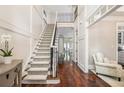 Bright foyer showcasing an open staircase, hardwood floors, and elegant trim at 612 Concord Lake Se Cir, Smyrna, GA 30082