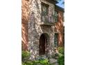 Arched stone entry with a Juliet balcony and manicured landscaping offers inviting curb appeal at 612 Concord Lake Se Cir, Smyrna, GA 30082