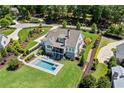 Aerial view of the house featuring pool, backyard, garden, driveway and neighborhood at 115 Trinity Hollow Dr, Canton, GA 30115