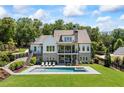 Stunning backyard with a modern pool, lounging area, and staircase leading to upper level porch at 115 Trinity Hollow Dr, Canton, GA 30115