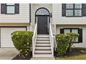 Inviting front entrance featuring a charming porch and well-maintained landscaping at 4733 Julian Way, Acworth, GA 30101