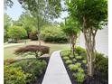 Pathway leading to a home, enhanced by artfully arranged shrubbery and flowerbeds with decorative mulch at 5258 Tallgrass Nw Way, Kennesaw, GA 30152