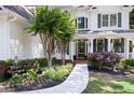 Close-up of the front yard showcasing a gracefully curved walkway and meticulously maintained flower beds at 5258 Tallgrass Nw Way, Kennesaw, GA 30152