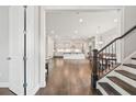 Open-concept design featuring hardwood floors seamlessly connecting the living, dining, and kitchen areas at 993 Harvest Park Ln, Suwanee, GA 30024