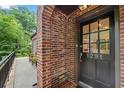 Brick exterior with a black front door, featuring sidelights and the house number at 1291 Stillwood Ne Dr, Atlanta, GA 30306