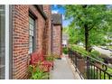 Inviting porch area with a red bench and iron railing, perfect for relaxation at 1291 Stillwood Ne Dr, Atlanta, GA 30306