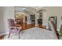 Spacious foyer featuring hardwood floors, neutral walls, and a decorative rug and chair at 2073 Woodside Park Dr, Woodstock, GA 30188