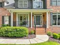 Inviting front porch with brick steps and detailed columns offers an eye-catching entrance at 2073 Woodside Park Dr, Woodstock, GA 30188