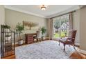 Well-lit home office with large windows, hardwood floors, and neutral paint at 2073 Woodside Park Dr, Woodstock, GA 30188