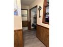 Hallway with decorative wood paneling on the lower portion of the wall and stylish gray wood flooring at 36 Mount Tabor Rd, Covington, GA 30014