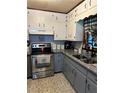 Charming kitchen with white cabinets, gray lower cabinets, stainless steel appliances, and granite countertops at 36 Mount Tabor Rd, Covington, GA 30014