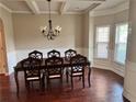 Formal dining room with hardwood floors, chandelier, and large dining table at 3897 Valley Bluff Ln, Snellville, GA 30039