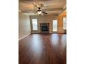Inviting living room with hardwood floors, coffered ceiling, and stone fireplace at 3897 Valley Bluff Ln, Snellville, GA 30039