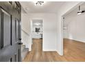 Bright foyer featuring hardwood floors, white walls, and a view into the kitchen and living room at 1111 Fieldgate Rd, Lawrenceville, GA 30044