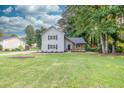 Inviting two-story home with a lush green lawn, beautiful landscaping, and cozy curb appeal at 1111 Fieldgate Rd, Lawrenceville, GA 30044