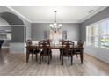 Elegant dining room with wood floors, chandelier, and large window at 143 Monarch Way, Hiram, GA 30141