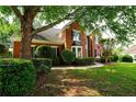 Brick home featuring manicured landscaping, bay window, and a welcoming American flag at 1601 Haven Crest Ct, Powder Springs, GA 30127