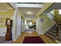 Inviting foyer with hardwood floors, a staircase, and view into the living room at 1601 Haven Crest Ct, Powder Springs, GA 30127