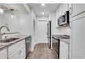 Well-lit kitchen with granite countertops, stainless steel appliances, and wood floors at 206 Tuxworth Cir, Decatur, GA 30033