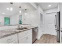 Bright kitchen with granite countertops, stainless steel appliances, and wood floors at 206 Tuxworth Cir, Decatur, GA 30033