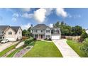 Beautiful two-story home with a long driveway, lush lawn and professional landscaping at 224 Mountain View Dr, Woodstock, GA 30188