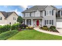 A well-maintained home with professional landscaping, green lawn, and a charming red front door at 224 Mountain View Dr, Woodstock, GA 30188