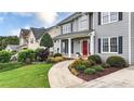 A well-manicured lawn and lush landscaping complement this charming two-story home at 224 Mountain View Dr, Woodstock, GA 30188