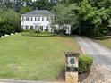 Beautiful two-story home featuring manicured lawn, long driveway, and traditional details at 640 Belgrave Ln, Tucker, GA 30084