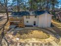 This home features a spacious backyard with a multi-level deck, patio, and lush green lawn at 1890 Carla Dr, Morrow, GA 30260