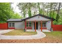 Charming single-story home with gray siding, red accents, covered porch and well manicured lawn at 3479 Thompson Dr, Atlanta, GA 30331