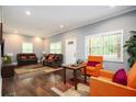 Bright living room with hardwood floors, two brown couches, and an orange chair at 3479 Thompson Dr, Atlanta, GA 30331