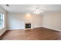 Spacious living room features hardwood floors, fireplace, and a large window at 841 Holly Meadow Dr, Buford, GA 30518