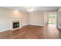 Bright living room featuring hardwood floors, fireplace and a sliding door at 841 Holly Meadow Dr, Buford, GA 30518