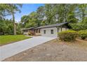 A freshly renovated home featuring a newly paved driveway and lush landscaping at 3614 N Druid Hills N Rd, Decatur, GA 30033