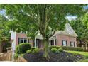 Beautiful brick home featuring manicured landscaping and a paved driveway leading to the welcoming front entrance at 4085 Hillcrest View Ct, Suwanee, GA 30024