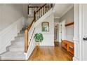Traditional foyer featuring hardwood floors, staircase, and elegant trim details at 5524 Wedgewood Sw Ct, Lilburn, GA 30047