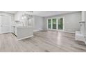 View of the open living area showcasing modern kitchen, patio doors and fireplace at 113 Tuxworth Cir, Decatur, GA 30033