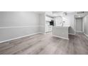 Open-concept living room featuring hardwood floors and seamless flow into the kitchen at 113 Tuxworth Cir, Decatur, GA 30033