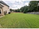 Spacious backyard with lush green lawn and mature trees, providing a serene and private outdoor space at 4482 Ridge Mill Ne Ter, Douglasville, GA 30135
