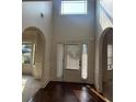 Bright foyer with dark wood floors, transom window, and arched doorways at 4482 Ridge Mill Ne Ter, Douglasville, GA 30135