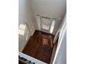 View of the foyer showing the transom windows, wood floors, and front door at 4482 Ridge Mill Ne Ter, Douglasville, GA 30135