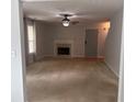 Spacious living room with a fireplace, neutral carpet, and a gray front door at 5425 Village Green Sq, Norcross, GA 30093