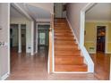 Inviting foyer with hardwood floors and a staircase leading to the upper level at 930 Cedar Bluff Sw Trl, Lilburn, GA 30047