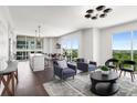 Open concept living room with modern furnishings, hardwood floors, and picturesque city views at 1820 Peachtree St # 1607, Atlanta, GA 30309