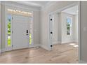 Bright entryway featuring hardwood floors, a sidelight window, and an open doorway at 2517 Hampton Park Ct, Marietta, GA 30062