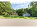 Property featuring a brick home and a large metal outbuilding with generous lawn at 5670 Lanny Dr, Powder Springs, GA 30127